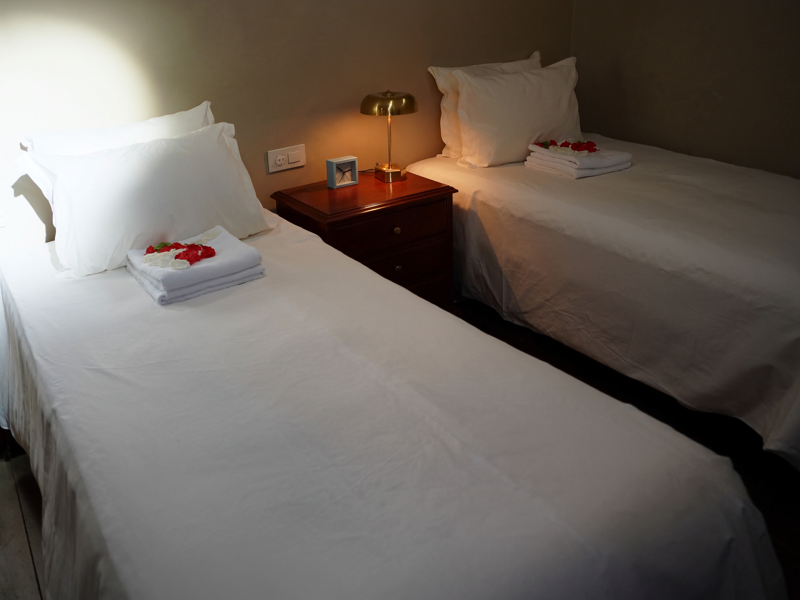 Two single beds in a Super Deluxe Room at OPS Guest House, Dhulagori
